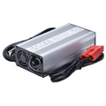 Amped Outdoors 20A Battery Charger with a durable silver metal casing, cooling fan, labeled top panel, black power cords, and red battery clip connectors designed for efficient charging.