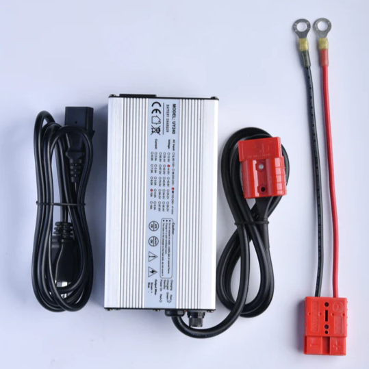 Amped Outdoors 20A Battery Charger with a silver metal casing, black power cord, and additional red and black connection cables designed for charging fishing and marine batteries.