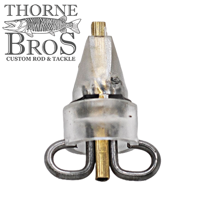 Close-up view of the Angling Revolution "The One" Clevis Assembly, a clear plastic and metal fishing tackle component with dual swivel loops, displayed with Thorne Bros logo.