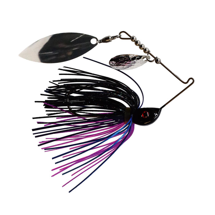 Bassman Spinnerbaits Compact Series Tandem Blades fishing lure with black, purple, and blue skirt, featuring two silver spinning blades and a weighted head for freshwater fishing.