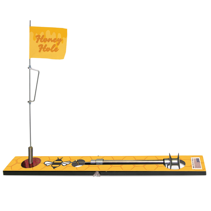 Beaver Dam Honey Hole Tip-Up ice fishing device with a yellow flag labeled "Honey Hole," featuring a bee graphic on a hexagonal patterned base for musky fishing tackle.