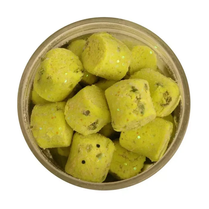 Container filled with bright yellow Berkley Gulp! Trout Nuggets fishing lures featuring small glitter flakes, designed for effective fishing tackle use.