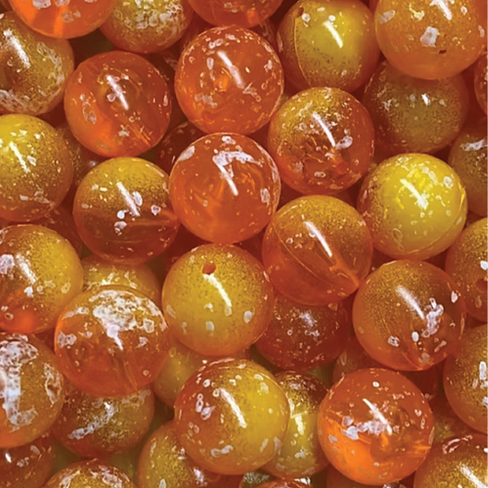 Close-up view of translucent orange and yellow fishing beads with a glossy finish, used as fishing tackle by Bloop Bead Co. in musky and ice fishing gear.
