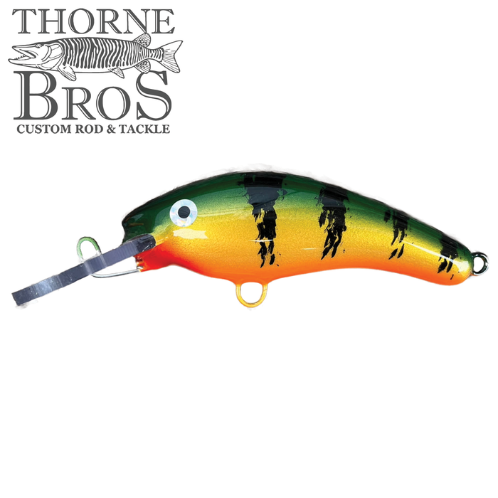 Blue Water Baits 5" K.O. Shad fishing lure featuring a green, yellow, and orange body with black stripes, designed for effective fishing tackle use.