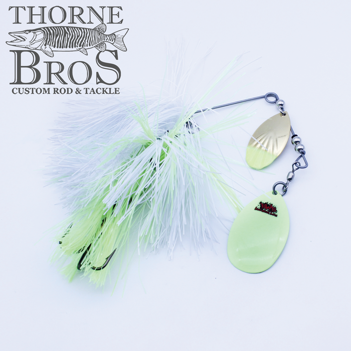 Blue Water Baits Gong Show 10 spinnerbait fishing lure with white and pale green skirt, two dual metal blades, and a black treble hook, designed for musky fishing.