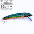 B&N Magnum Claw - 11" Aluminum Lip fishing lure with green and blue pattern, red underside, clear diving lip, and treble hooks designed for musky fishing tackle.
