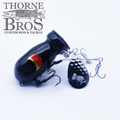 Black fishing lure with a bulbous body and metallic spinner blade attached, featuring the text Bomb Squad C-4 Flap Tail, designed for musky fishing tackle.