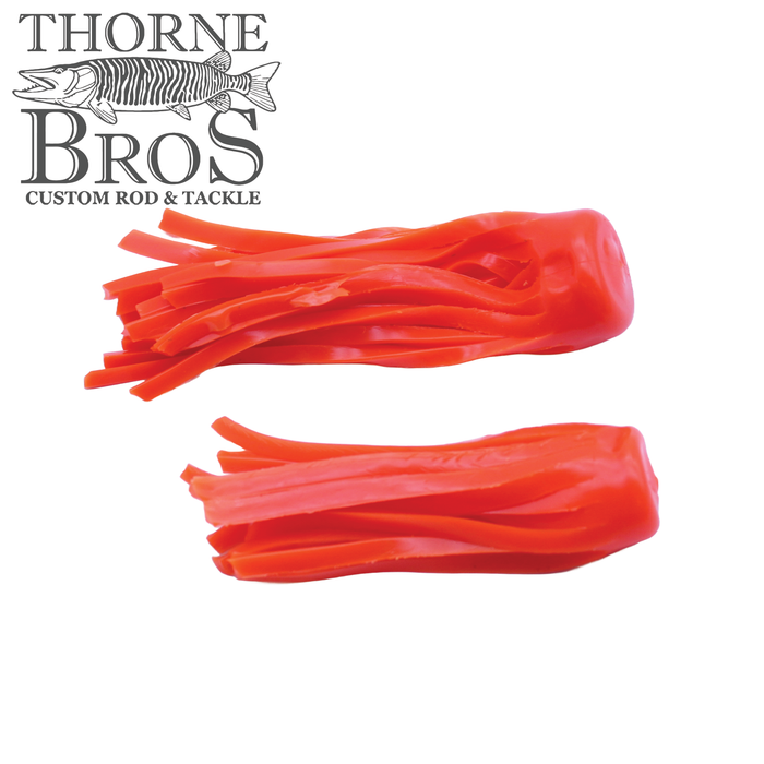 Two bright orange Boss Shad Hybrid Replacement Skirts (All Sizes) fishing lure skirts made of flexible material with multiple thin strips for enhanced movement in water.