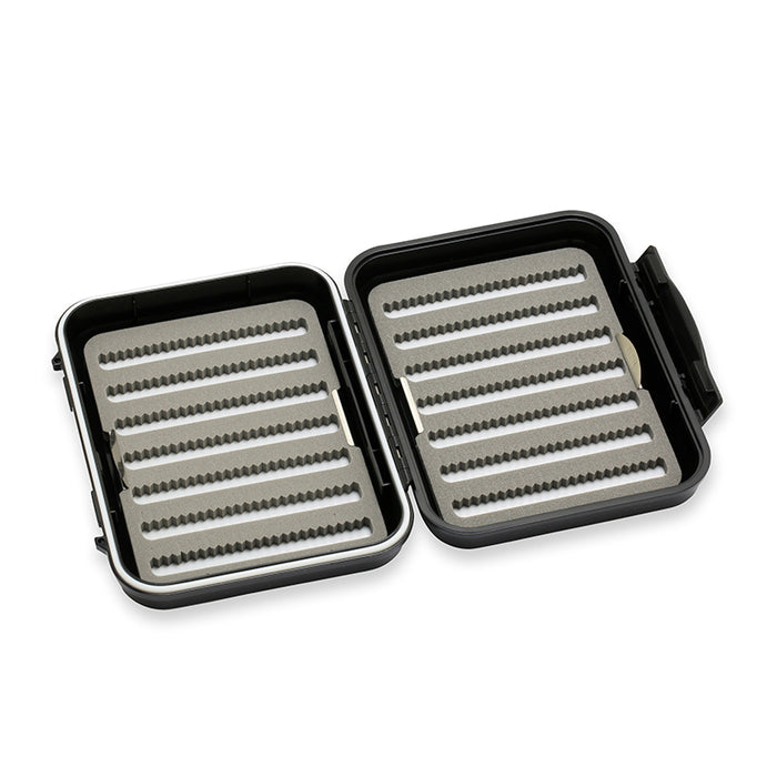 Open black and gray C&F Design Fly Boxes with foam inserts featuring multiple rows of slotted grooves for securely holding fishing flies and tackle.