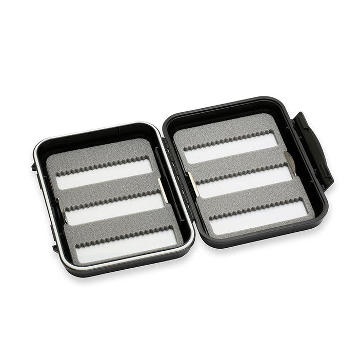 Open black hard case with foam inserts featuring three slotted rows on each side, designed for organizing fishing tackle, identified as C&F Design Fly Boxes.