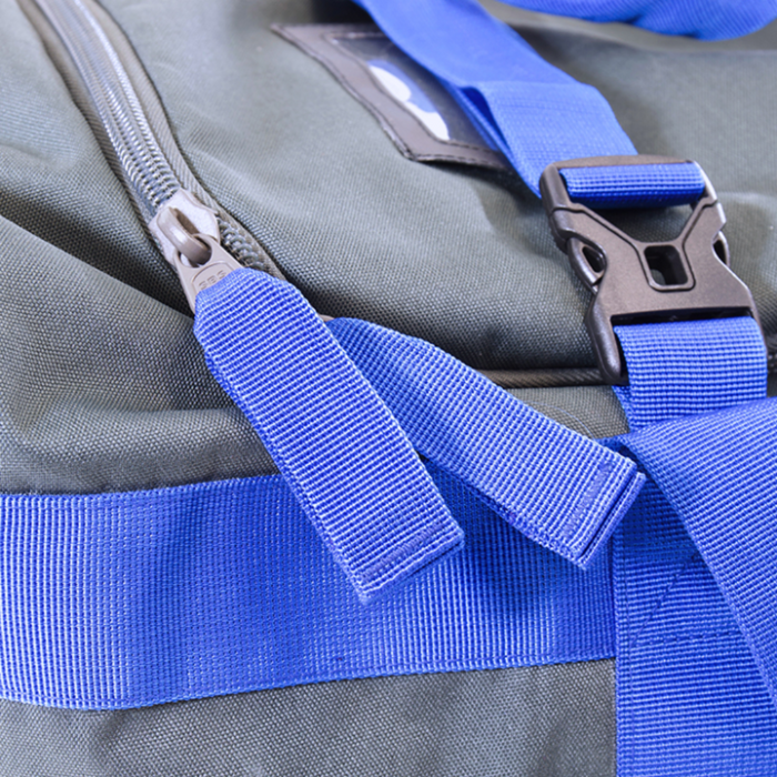 Close-up of durable gray and blue Clam Gear Bag fabric featuring sturdy zipper pulls and an adjustable blue strap with a black plastic buckle, designed for fishing tackle storage.