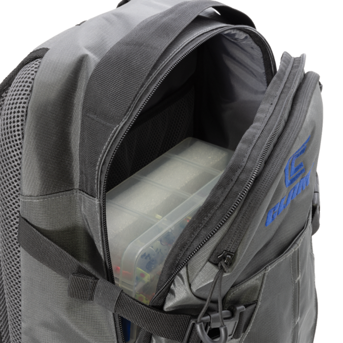 Clam Slim Backpack in dark gray fabric with multiple zippered compartments, including one open front pocket showing a clear fishing tackle box inside.
