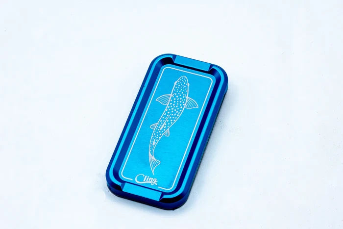 Cling Mag Grab Double Stack in blue with a white fish graphic on top, designed as a compact, durable fishing tackle accessory for securely holding items.