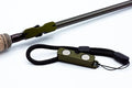 Cling Mag Grab Rod Rack in deep green attached to a fishing rod handle, featuring magnetic clips and a black adjustable cord for secure fishing tackle organization.
