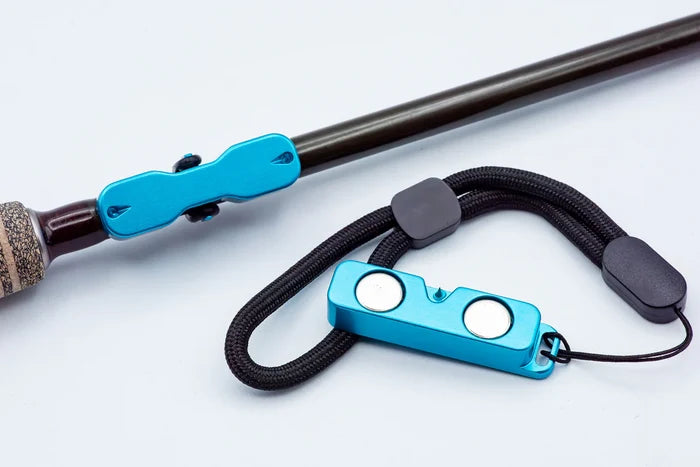 Cling Mag Grab Rod Rack in blue securely attached to a fishing rod, showing magnetic support for organizing fishing tackle and rods.