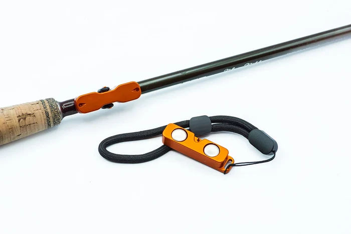 Cling Mag Grab Rod Rack shown detached, featuring orange magnetic components and a black adjustable cord designed to securely hold a fishing rod handle.