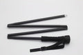 Black collapsible wading staff segmented into four parts, featuring a foam grip and adjustable wrist strap for secure handling during fishing activities.