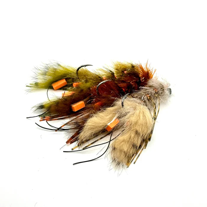 Craw Changer fishing lures featuring lifelike feathers and fur in natural colors with multiple hooks and orange accents designed for musky and fly fishing tackle.