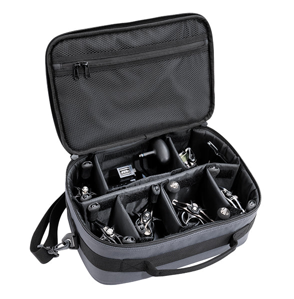 Daiwa D-Vec Reel Bag open to show multiple compartments holding various fishing reels in a black padded case with a zippered mesh pocket inside the lid.
