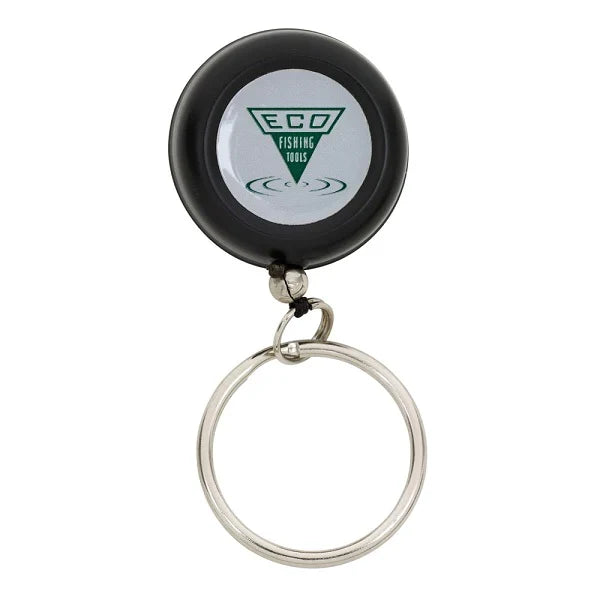 Dr. Slick ECO Reel Pin-on Black Bulk featuring a round black retractable reel with a metal keyring, displaying the ECO Fishing Tools logo for fishing tackle organization.