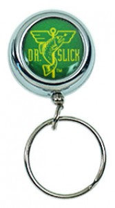 Dr. Slick Pin on and Clip on Reels featuring a compact, round, silver metal casing with a green logo, designed for easy attachment to fishing gear or accessories.