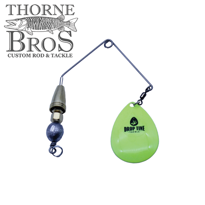 Close-up of a Drop Tine Growler Arm Attachment fishing lure with a metal wire arm, weighted lead component, brass swivel, and bright green teardrop-shaped spinner blade featuring the Drop Tine Tackle logo, designed for musky fishing.