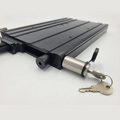 DuraSafe MKA-32/51 Bracket Lock shown in close-up with a black metal body and a cylindrical locking mechanism holding two keys, designed for secure mounting of fishing rods and reels.