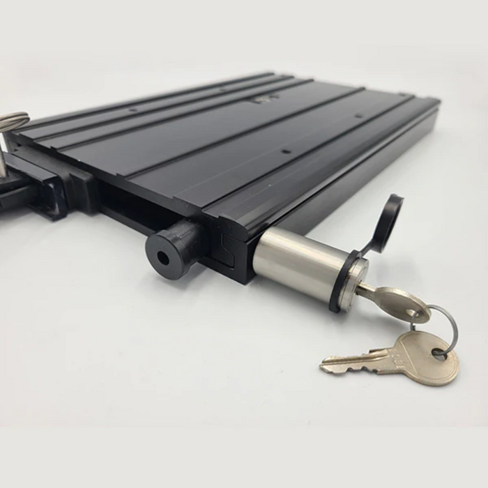 DuraSafe MKA-32/51 Bracket Lock shown in close-up with a black metal body and a cylindrical locking mechanism holding two keys, designed for secure mounting of fishing rods and reels.