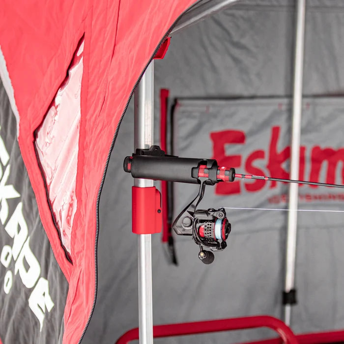Eskimo E-Hub Deadstick Holder mounted inside a red and gray Eskimo ice fishing shelter, holding a fishing rod with reel securely in place for hands-free fishing.