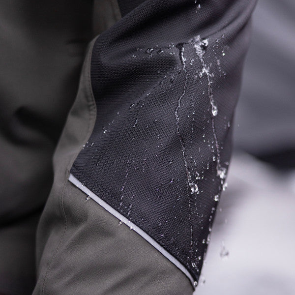 Close-up of water beading on the fabric of the Eskimo Expedition Jacket - Men's, showing durable, water-resistant material designed for cold weather and fishing activities.
