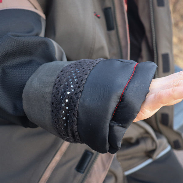 Close-up view of a sleeve cuff with black breathable fabric and red stitching detail on an Eskimo Explorer Jacket - Youth, designed for outdoor fishing and cold weather protection.