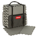 Stack of interlocking gray foam floor tiles with a black carrying case featuring a handle and straps, labeled Eskimo Floor Tile Kits, designed for added comfort and insulation.