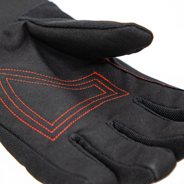 Eskimo Hole Hopper Glove shown in close-up, featuring black fabric with textured grip areas and orange stitched detailing designed for enhanced control in fishing tackle handling.