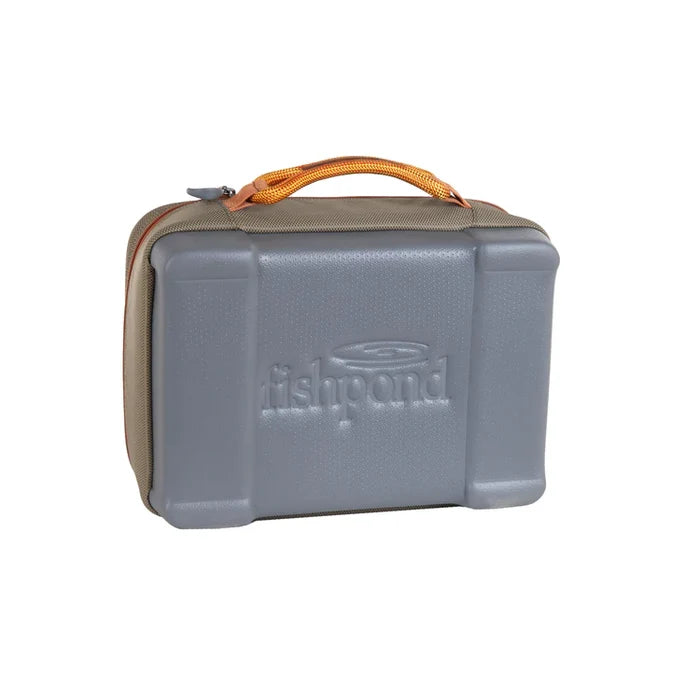Fishpond Honcho Reel Case with a durable molded exterior and tan fabric body, featuring an orange carrying handle designed for secure storage of fishing reels.