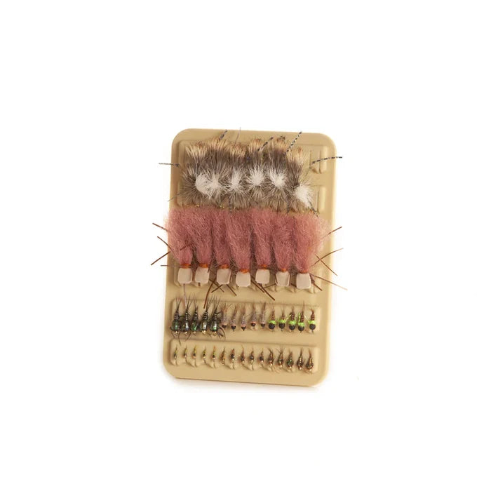 Fishpond Tacky Mat 3x5 holding various detailed fishing flies organized in rows, designed to securely hold fishing tackle for fly fishing enthusiasts.
