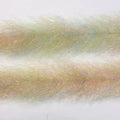 Close-up of translucent, fine synthetic fibers with iridescent hues in pale yellow and subtle pink tones used as fishing lure material, named Flash Blend Baitfish Brush.