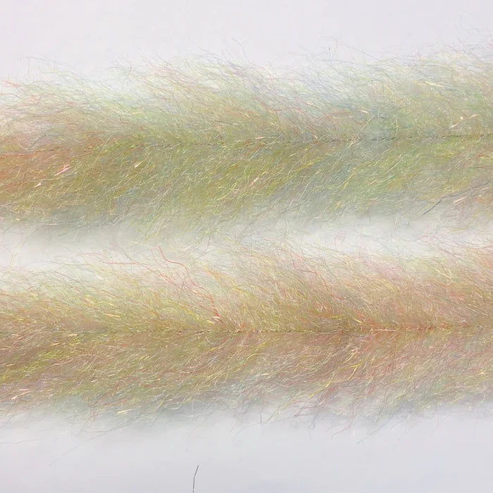 Close-up of translucent, fine synthetic fibers with iridescent hues in pale yellow and subtle pink tones used as fishing lure material, named Flash Blend Baitfish Brush.