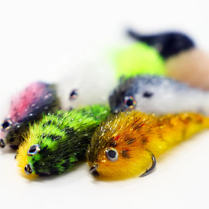 Close-up of colorful FlyMen Minnow Changer 2/0 fishing lures featuring detailed eyes and textured bodies designed for effective fishing tackle use.