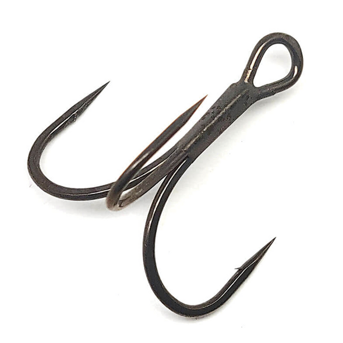 Close-up of a Gamakatsu G-Finesse Short Shank Treble Hooks showing three sharp, black metal points with barbs designed for fishing tackle and lure applications.