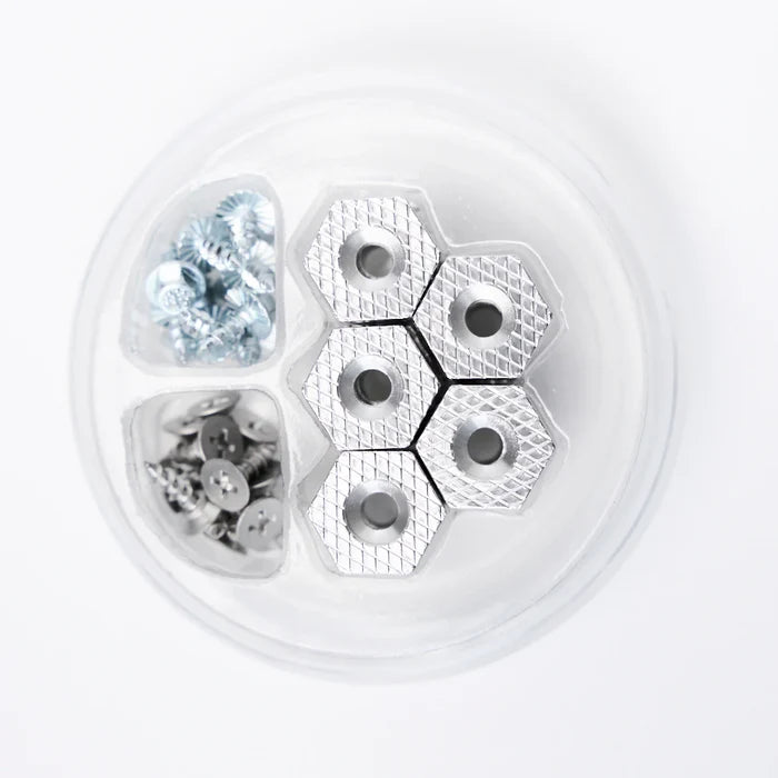 Grundens Hexagrip Cleat and Stud Pack showing six silver hexagonal cleats with textured grips and two compartments containing metal screws and studs for fishing tackle gear.