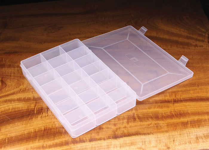 Hareline 21 Comp. Hook Box open to show 21 individual transparent compartments designed for organizing fishing tackle and hooks, placed on a wooden surface.