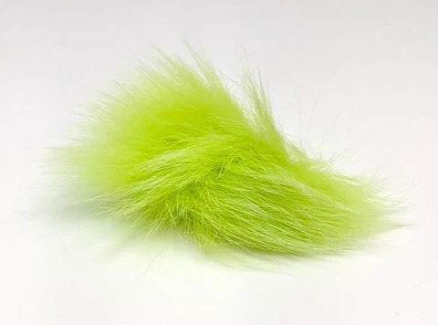 A close-up of bright chartreuse Hareline Arctic Fox Hair, a soft, fluffy material used in fishing tackle for fly tying and lure customization.