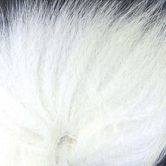 Hareline Arctic Fox Tail Hair in white, showing soft, fine fur fibers used for crafting fishing lures in fly fishing and musky tackle.