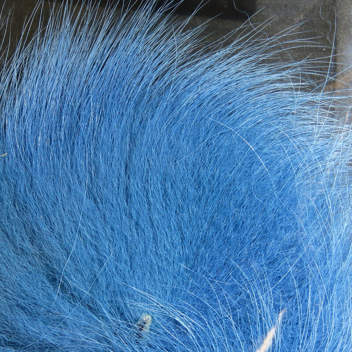 Close-up view of soft, fine strands of Hareline Arctic Fox Tail Hair in bright blue, suitable for fly fishing and custom fishing tackle applications.