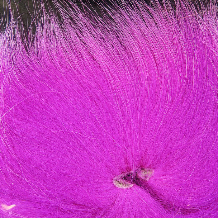 Close-up of vibrant pink Hareline Arctic Fox Tail Hair, soft and fine fur designed for fishing tackle and fly fishing lure crafting.