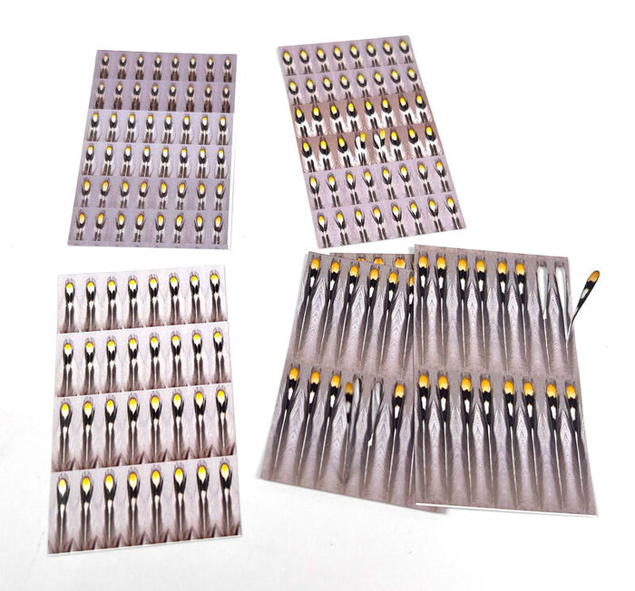 Multiple sheets of Hareline Artificial Jungle Cock feathers displayed on a white background, used for fly fishing and fishing tackle customization.