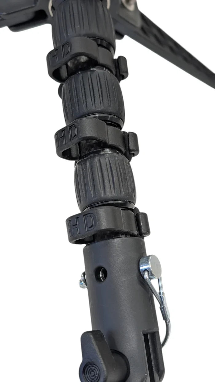 Close-up of black HD Innovations HD Pole Clips (3-Pack) securely attached to a segmented fishing rod handle, showcasing durable grips and fastening mechanism.