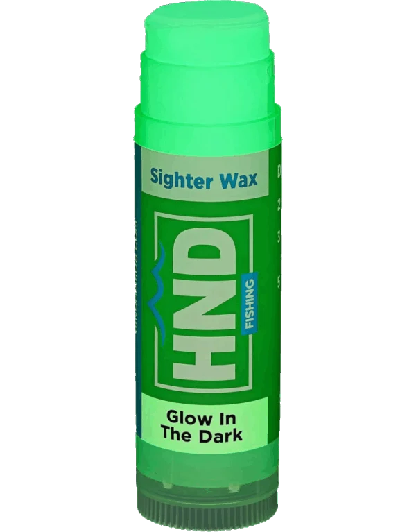 Green cylindrical tube of High and Dry Sighter Wax designed for fishing, labeled with glow-in-the-dark features to enhance visibility of fishing tackle during low light conditions.