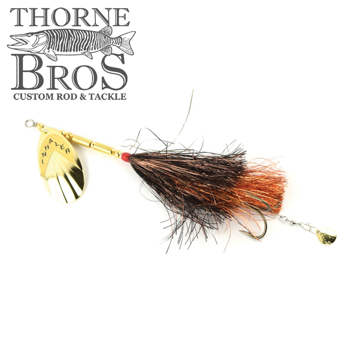 Inhaler 70 Firefly fishing lure with gold spinner blade, black and copper feather skirt, and treble hook designed for musky fishing by Thorne Bros.