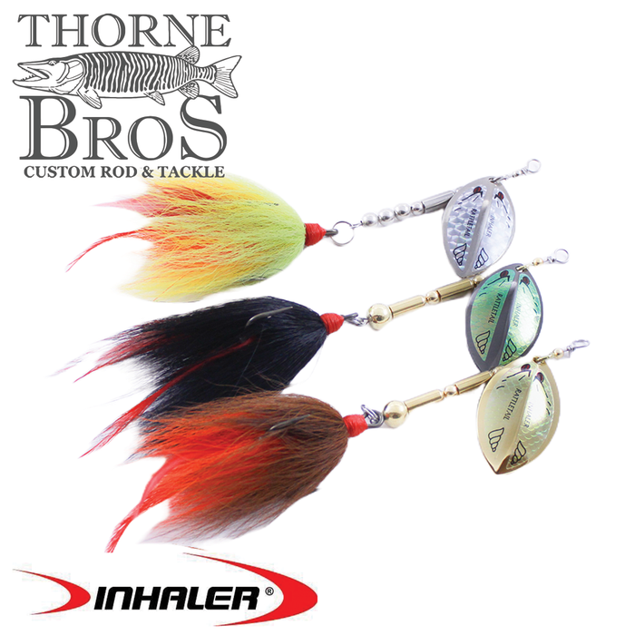 Three Inhaler Rattletail fishing lures featuring metal spinner blades and colorful feathered tails in yellow, black, and orange for musky fishing tackle.